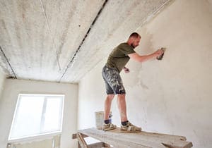 apartment remodel worker is standing on wooden st 2023 11 27 05 32 20 utc 1